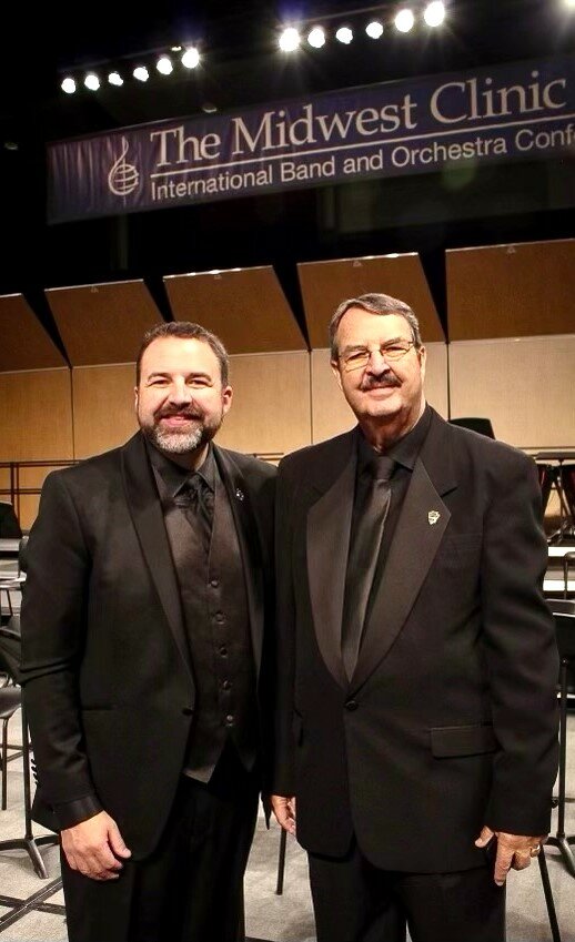 Jeremy Strickland, left, director of bands at Tyler Junior College, and his father, George, at the Midwest Clinic International Band and Orchestra Conference in Chicago, where the TJC band performed.
